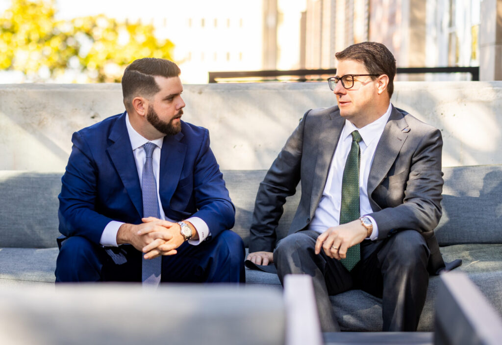 Two Capital City Consulting consultants in conversation on an office sofa